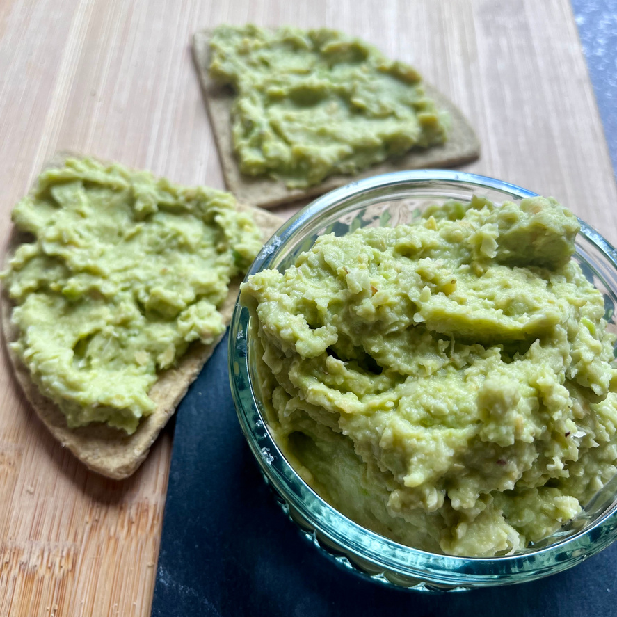 green Fava Bean Hummus in a glass jar with Stockan's Oatcakes next to it
